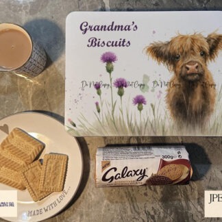 Highland cow calf standing in a purple thistle field on five templates